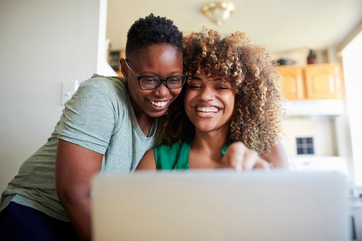 black women smiling and looking at computer