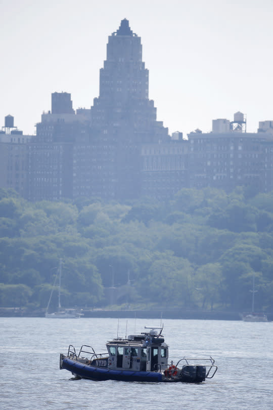 <p>An NYPD boat sits on the Hudson River near the site of small plane crash, Saturday, May 28, 2016, in North Bergen, N.J. A World War II vintage P-47 Thunderbolt aircraft crashed into the river Friday, May 27, killing its pilot. (AP Photo/Julio Cortez) </p>