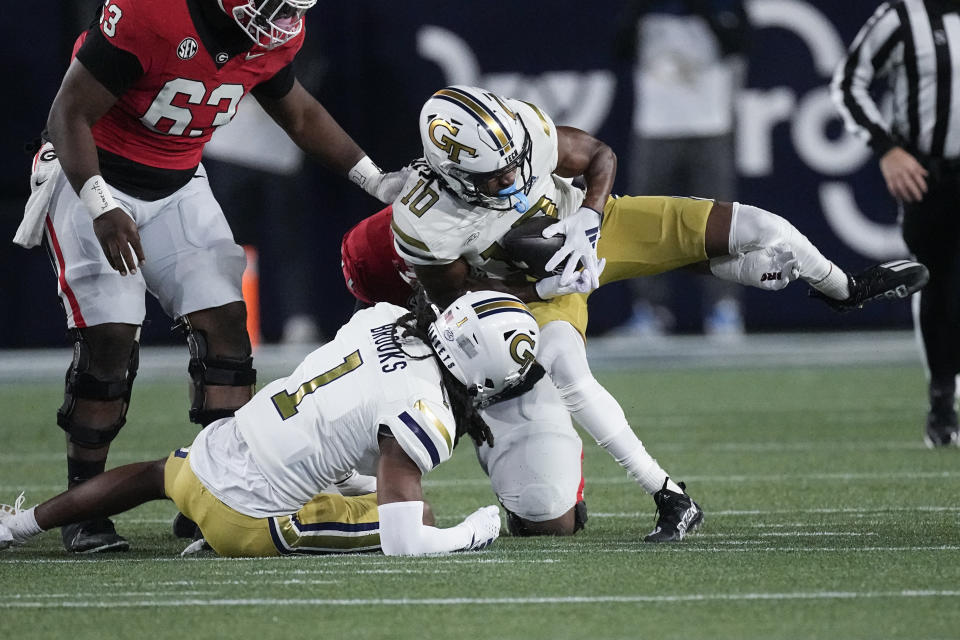 Georgia Tech defensive back Kenan Johnson (10) recovers a Georgia fumble during the first half of an NCAA college football game, Saturday, Nov. 25, 2023, in Atlanta. (AP Photo/John Bazemore)