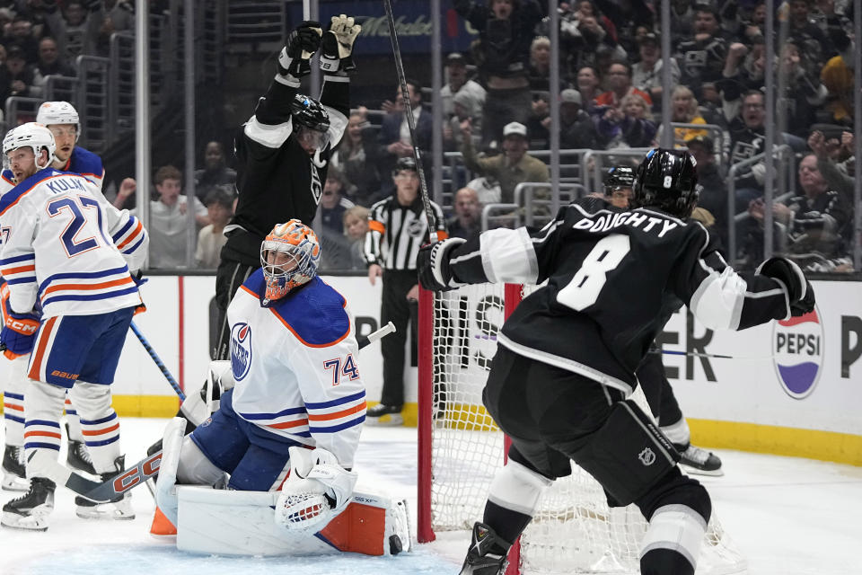 Los Angeles Kings defenseman Drew Doughty, right, celebrates his goal with center Anze Kopitar, center, as Edmonton Oilers goaltender Stuart Skinner, second from right, looks on during the second period in Game 3 of an NHL hockey Stanley Cup first-round playoff series Friday, April 26, 2024, in Los Angeles. (AP Photo/Mark J. Terrill)