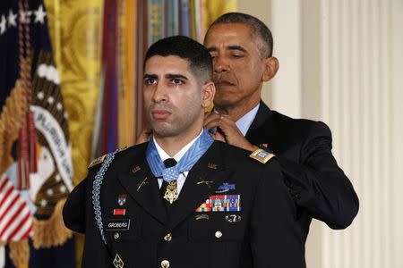 U.S. President Barack Obama awards retired U.S. Army Captain Florent Groberg the Medal of Honor during a White House ceremony in Washington November 12, 2015. REUTERS/Kevin Lamarque