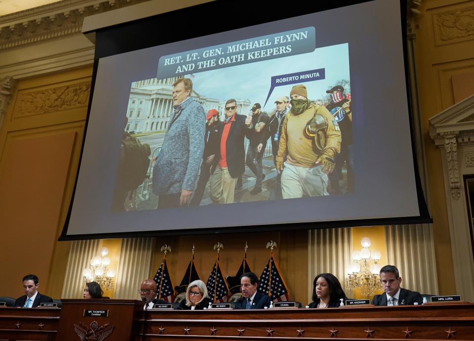 A photograph of former national security adviser to former President Donald Trump, Michael Flynn, with Oath Keepers is projected on a large screen during a public hearing of the House committee to investigate the January 6 attack on the U.S. Capitol.