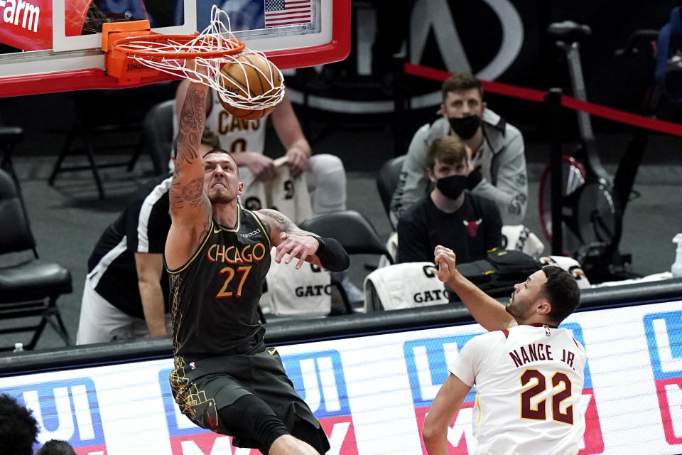 Chicago Bulls center Daniel Theis dunks as Cleveland Cavaliers forward Larry Nance Jr. watches during the second half of an NBA basketball game in Chicago, Saturday, April 17, 2021. (AP Photo/Nam Y. Huh)