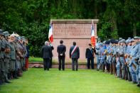 Reenactors dressed as French and German soldiers gather at the German WWI cemetery of Troyon, eastern France, as part of the 100-year commemoration of the Battle of Verdun