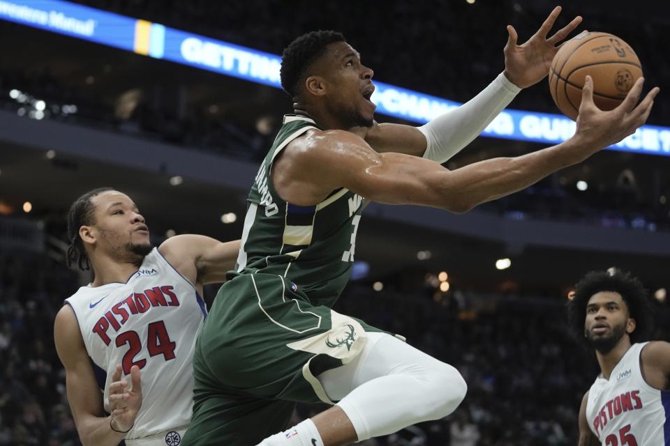 Milwaukee Bucks' Giannis Antetokounmpo shoots past Detroit Pistons' Kevin Knox II during the first half of an NBA basketball game Saturday, Dec. 16, 2023, in Milwaukee. (AP Photo/Morry Gash)