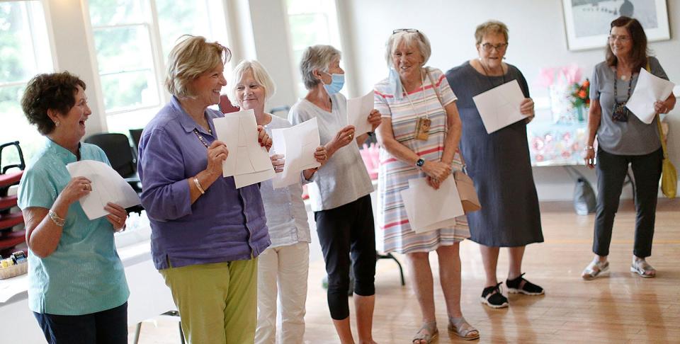 Friends sing "Blue Hair Parody" for Mary "Mae" Ryan, of Milton, to celebrate her 100th birthday at the Milton Senior Center.