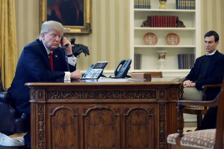 U.S. President Donald Trump, joined by his senior advisor and son-in-law Jared Kushner (R), speaks by phone with the Saudi Arabia's King Salman in the Oval Office at the White House in Washington, U.S. January 29, 2017. REUTERS/Jonathan Ernst