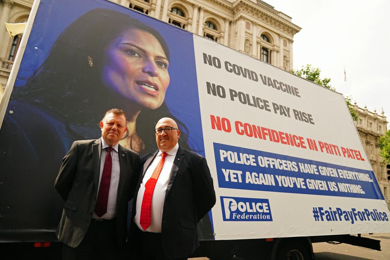 Chairman of the Police Federation John Apter (left) and Ken Marsh, Chairman of the Metropolitan Police Federation stand in front of an advertising van with a poster of Home Secretary Priti Patel as they deliver a letter to 10 Downing Street, London, setting out officers’ anger over a pay freeze and objections to the Government’s Beating Crime Plan (Victoria Jones/PA) (PA Wire)