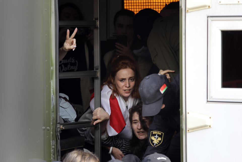Police officers detain protesters, pushing them into a police bus during an opposition rally to protest the official presidential election results in Minsk, Belarus, Saturday, Sept. 12, 2020. Daily protests calling for the authoritarian president's resignation are now in their second month and opposition determination appears strong despite the detention of protest leaders. (AP Photo)