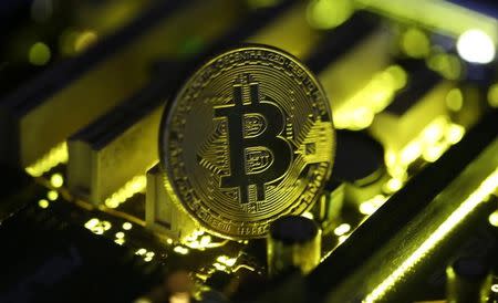 A copy of bitcoin standing on PC motherboard is seen in this illustration picture, October 26, 2017. REUTERS/Dado Ruvic/Files