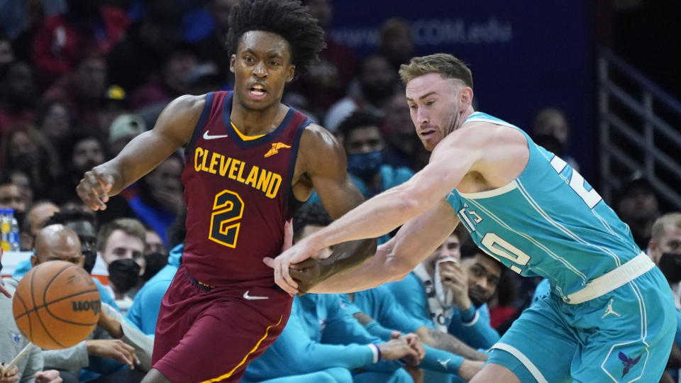 Cleveland Cavaliers' Collin Sexton (2) and Charlotte Hornets' Gordon Hayward (20) watch the ball during the second half of an NBA basketball game, Friday, Oct. 22, 2021, in Cleveland. Charlotte won 123-112. (AP Photo/Tony Dejak)