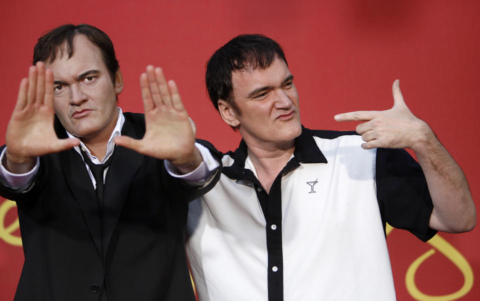 Director Quentin Tarantino (R) poses next to his wax figure after it was unveiled at Madame Tussauds in Hollywood, California August 7, 2009. REUTERS/Mario Anzuoni