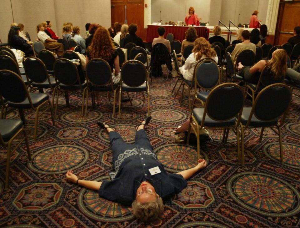 A participant lies on the floor for a relaxation/visualization exercise during the Awakening Aphrodite session of the Wise Women Weekend. The event was held at the Deauville in September 2003.