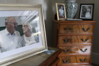 A photo of retired Gordon Bonner with his late wife Muriel on display in his home in Leeds, England, Saturday Jan. 23, 2021. For nine months, Bonner has been in the "hinterlands of despair and desolation" after losing Muriel, his wife of 63 years, to the coronavirus pandemic that has now taken the lives of more than 100,000 people in the United Kingdom. (AP Photo/Jon Super)