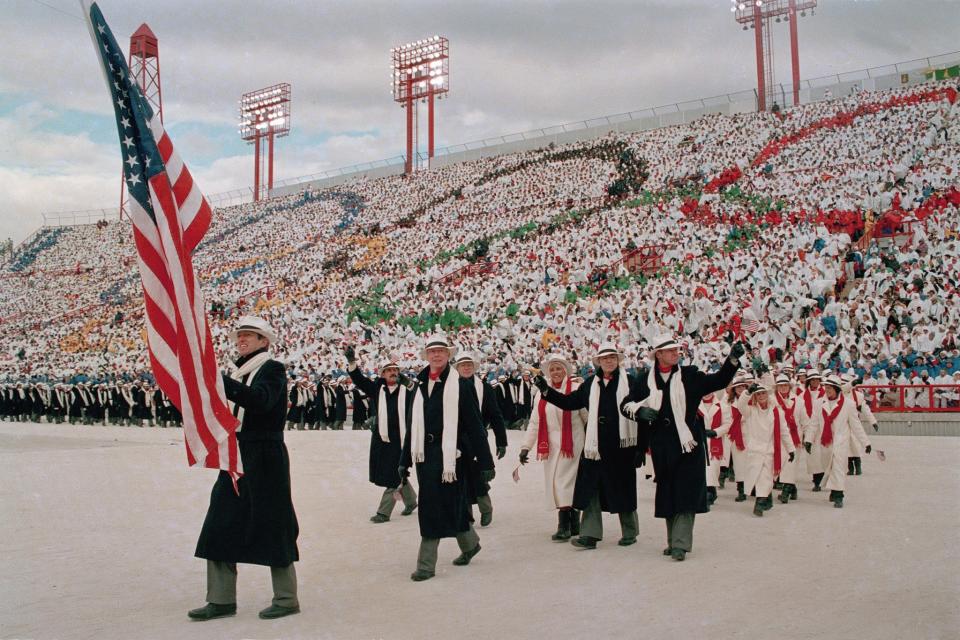 <p>Olympic athletes of Team USA entered the Opening Ceremony in Calgary, Canada, wearing long winter coats and white scarves and hats. (AP) </p>