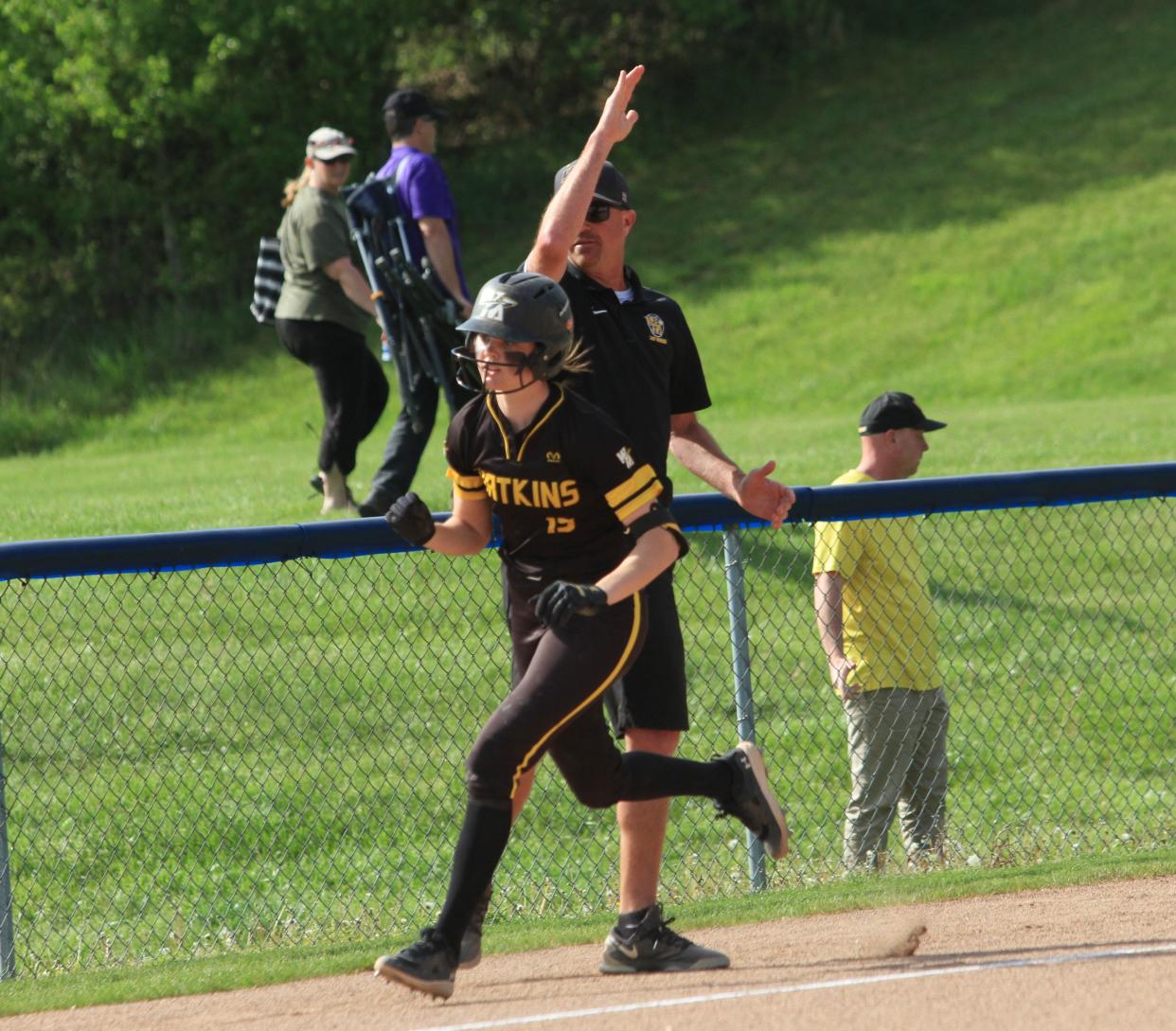 Watkins Memorial's Jordyn Wycuff celebrates her first-inning home run with coach Mike Jellison against Granville on Monday.