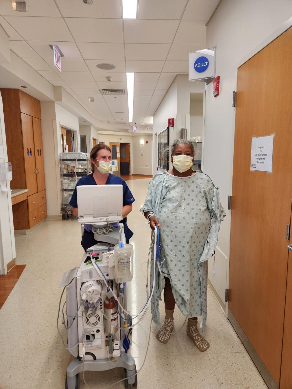 Carolyn McLeod walks the hall with a nurse before her heart transplant.
