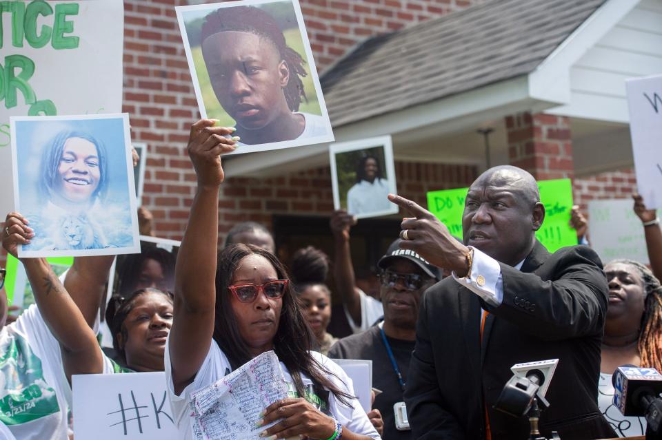 Civil rights attorney Ben Crump, right, points to a photo of Kadarius Smith held by his mother Kaychia Calvert, center, during a news conference calling for the release of the dashcam video of the death of her son during a news conference in Leland on Tuesday, April 16, 2024. Kadarius Smith, 17, was allegedly run down by a Leland Police cruiser on March 21.