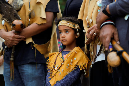 A young girl participates in the inaugural "Indigenous People's Day" during a sunrise celebration in downtown Los Angeles after the Los Angeles City Council voted to establish the second Monday in October as "Indigenous People's Day", replacing Columbus Day, in Los Angeles, California, U.S., October 8, 2018. REUTERS/Mike Blake