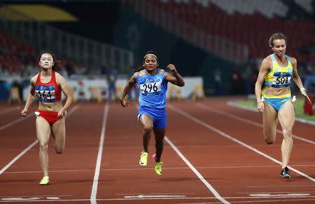 Athletics - 2018 Asian Games - Women's 100m Semi-final - GBK Main Stadium – Jakarta, Indonesia – August 26, 2018 – Liang Xiaojing of China, Dutee Chand of India and Olga Safronova of Kazakhstan compete. REUTERS/Darren Whiteside