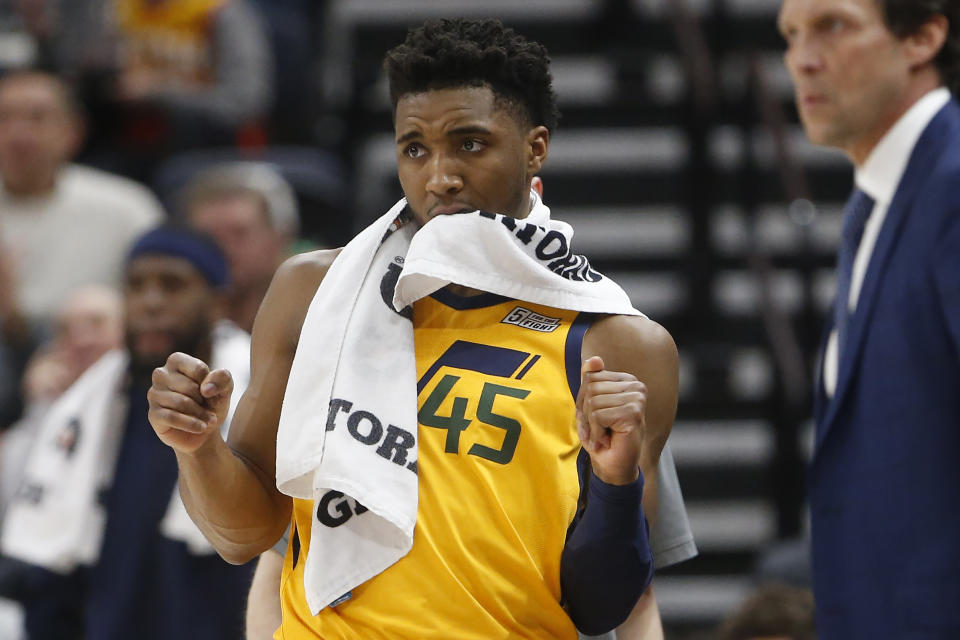 Utah Jazz guard Donovan Mitchell (45) reacts as he watches from the bench during the second half of an NBA basketball game against the San Antonio Spurs on Friday, Feb. 21, 2020, in Salt Lake City. (AP Photo/Rick Bowmer)
