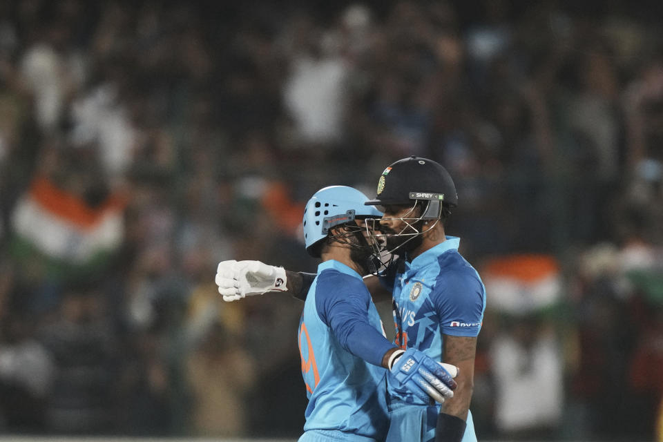 India's Hardik Pandya, right, hugs batting partner Dinesh Karthik to celebrate their win in the third T20 cricket match between India and Australia, in Hyderabad, India, Sunday, Sept. 25, 2022. (AP Photo/Mahesh Kumar A)