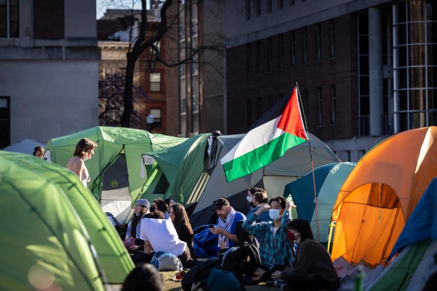 People sit outside tents at the pro-Palestinian demonstration encampment at Columbia University in New York on Wednesday April 24, 2024. (AP Photo/Stefan Jeremiah)