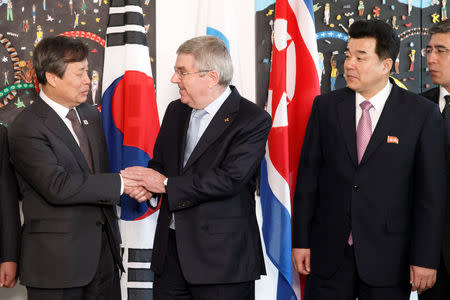 International Olympic Committee (IOC) President Thomas Bach from Germany, shakes hands with South Korean Sports Minister Do Jong-hwan, as North Korea's Olympic Committee President and Minister of Physical Culture and Sports Kim Il Guk looks on, prior a meeting with the IOC for their bid to co-host the 2032 Summer Olympics, at the IOC Headquarters in Lausanne, Switzerland, February 15, 2019. Salvatore Di Nolfi/Pool via REUTERS