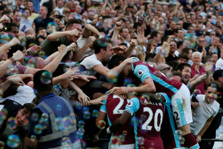 West Ham players and fans celebrate the opening goal scored by Cheikhou Kouyate against Swansea City at The London Stadium, in east London on April 8, 2017