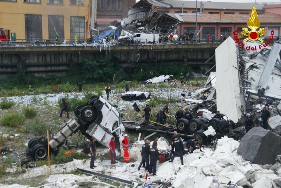 <em>Crushed vehicles lie amongst the concrete and steel following the collapse (AP)</em>