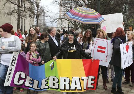 Supporters of same-sex marriage hold signs outside the Jefferson County Courthouse in Birmingham, Alabama February 9, 2015. REUTERS/Marvin Gentry