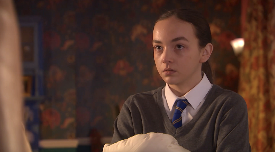 frankie osbourne in hollyoaks, a girl in school uniform stands looking upset