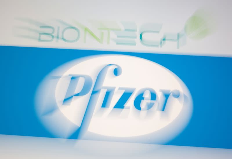 Biontech and Pfizer logos are seen on display in this illustration