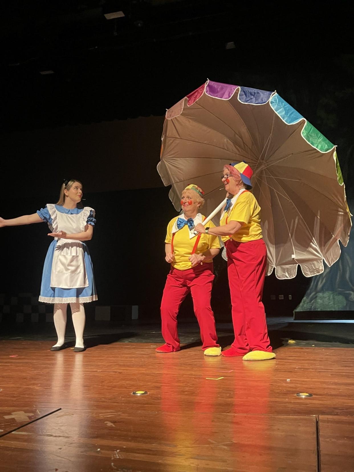 Alice, left, played by Elizabeth Jordan, tries to get information from Tweedledum, played by Lynn Brown, center, and Tweedledee, played by Linda Knight.