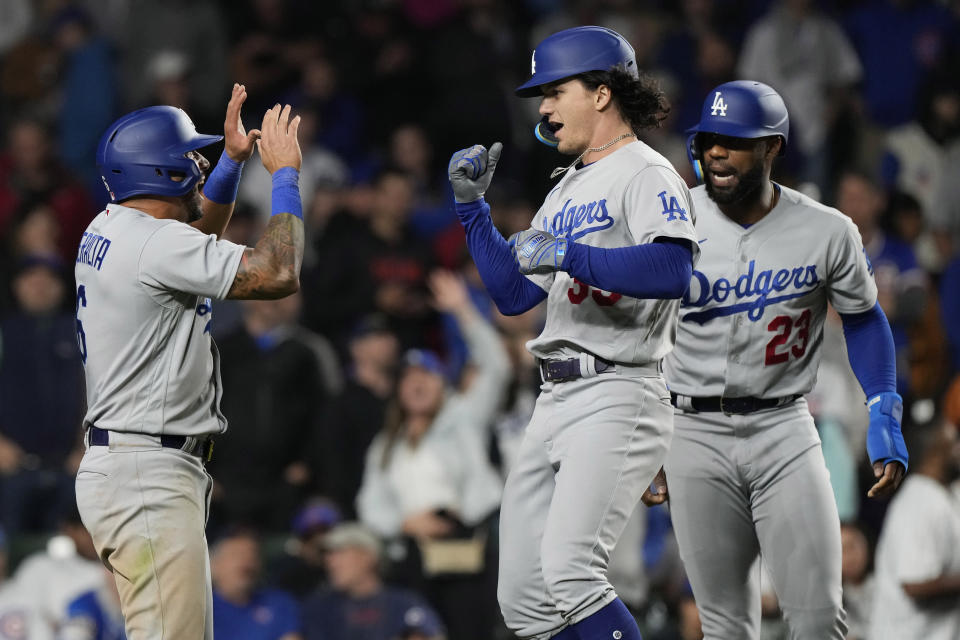 Los Angeles Dodgers' James Outman, center, celebrates with David Peralta, left, and Jason Heyward after hitting a grand slam against the Chicago Cubs during the ninth inning of a baseball game in Chicago, Thursday, April 20, 2023. The Dodgers won 6-2. (AP Photo/Nam Y. Huh)