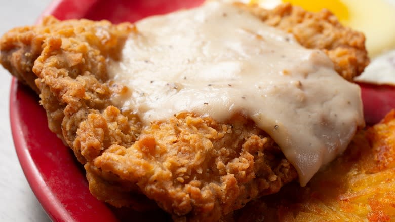 Closeup of country fried steak with white gravy