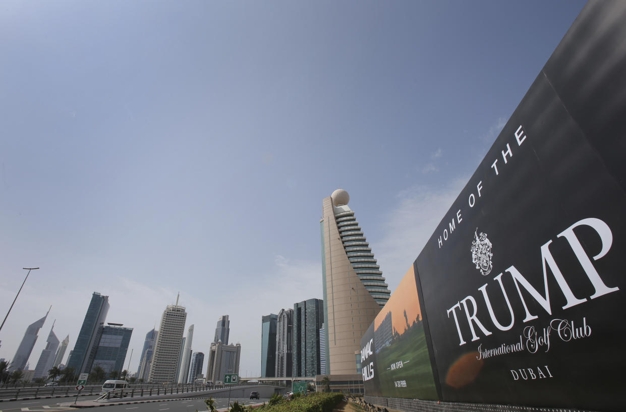 A giant billboard advertising the Trump International Golf Club hangs at the Dubai Trade Center roundabout, in Dubai, United Arab Emirates, Saturday, Feb. 18, 2017. Two of U.S. President Donald Trump's sons are in the United Arab Emirates for an invitation-only ceremony to open the Trump International Golf Club in Dubai on Saturday. (AP Photo/Kamran Jebreili)