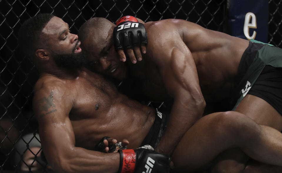 LAS VEGAS, NEVADA - MARCH 02: Tyron Woodley (L) and Kamaru Usman, of Nigeria, grapple during their welterweight title bout during UFC 235 at T-Mobile Arena on March 02, 2019 in Las Vegas, Nevada.  (Photo by Isaac Brekken/Getty Images)