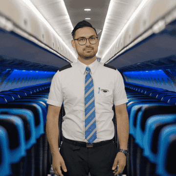 flight attendant gibing two thumbs up