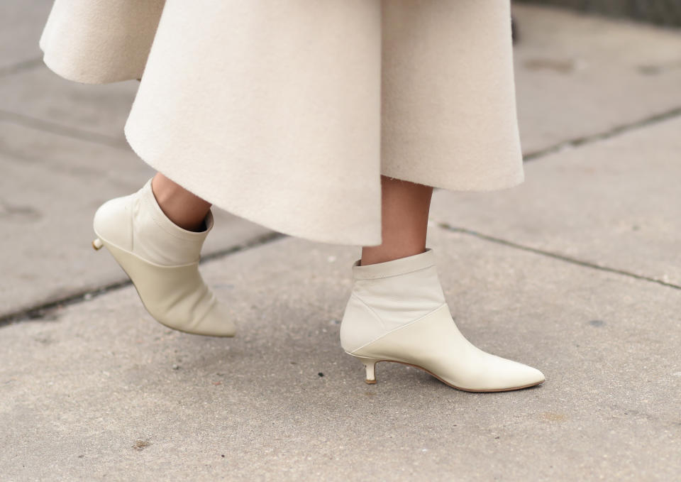 NEW YORK, NEW YORK - FEBRUARY 07: A guest is seen wearing white booties outside the Tadashi Shoji show during New York Fashion Week: Women's Fall/Winter 2019 on February 07, 2019 in New York City. (Photo by Daniel Zuchnik/Getty Images)