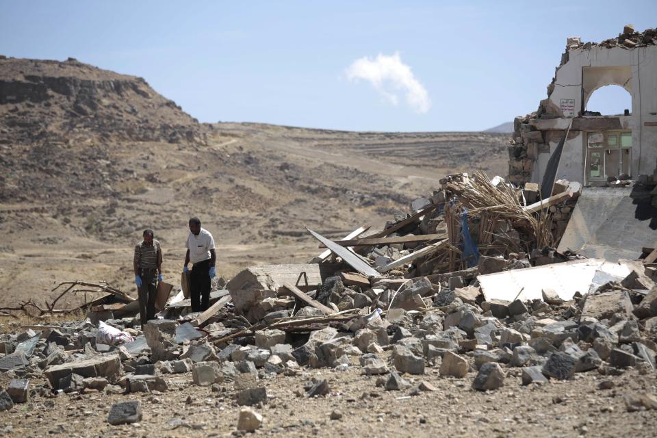 Forensic experts inspect the rubble of a house destroyed by a Saudi-led airstrikes in outskirts of Sanaa, Yemen, Thursday, Feb. 16, 2017. At least one Saudi-led airstrike near Yemen's rebel-held capital killed at least five people on Wednesday, the country's Houthi rebels and medical officials said. (AP Photo/Hani Mohammed)