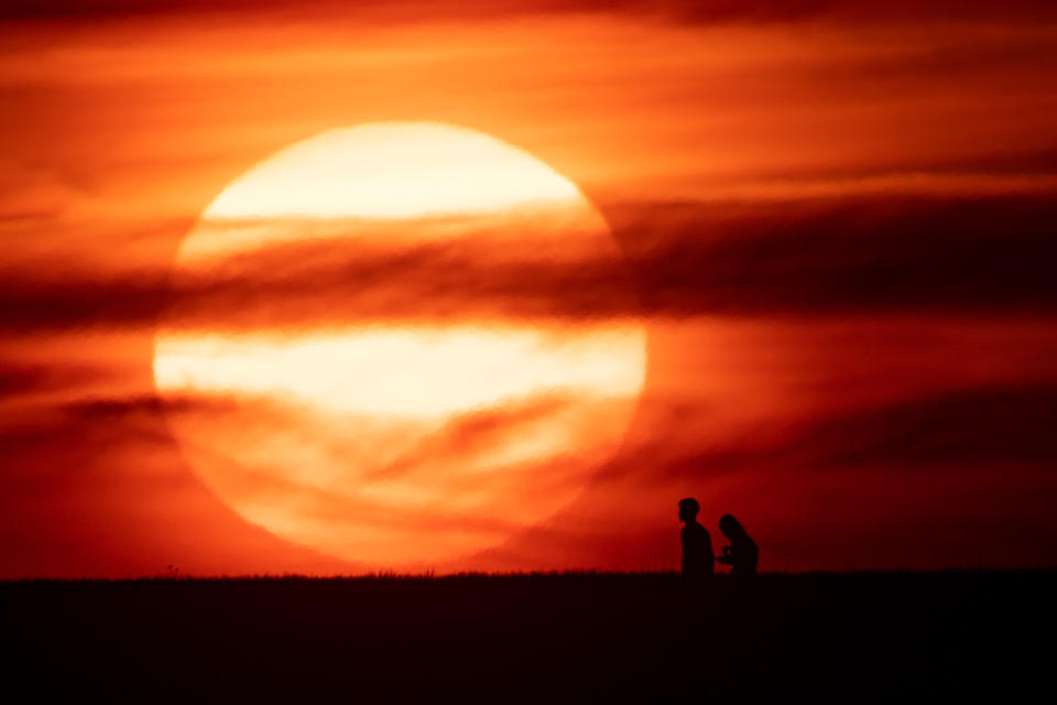 The sun sets in Chesterton, Warwickshire, as Britain braces for a June heatwave.