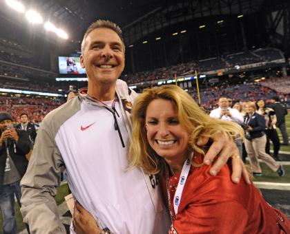 Dec 6, 2014; Indianapolis, IN, USA; Ohio State head coach Urban Meyer celebrates along with wife Shelley Meyer after the Buckeyes defeated Wisconsin 59-0 at the Big Ten championship at Lucas Oil Stadium. (Thomas J. Russo-USA TODAY Sports)