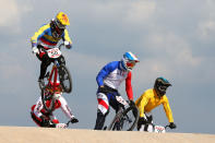 LONDON, ENGLAND - AUGUST 09: Emilio Andres Falla Buchely (L) of Ecuador clears a jump with the field during the Men's BMX Cycling Quarter Finals on Day 13 of the London 2012 Olympic Games at BMX Track on August 9, 2012 in London, England. (Photo by Phil Walter/Getty Images)