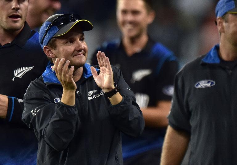 New Zealand's head coach Mike Hesson celebrates his team's win after their Cricket World Cup semi-final match against South Africa, at Eden Park in Auckland, on March 24, 2015