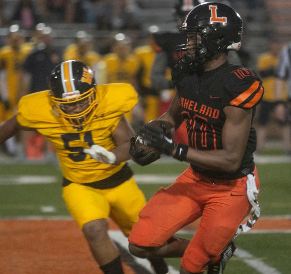 Lakeland High School's Tyler Williams (10) returns a 75 yard punt return for a touchdown against Winter Haven High School during the second quarter at Bryant Stadium in Lakeland Friday night. September 9, 2022.