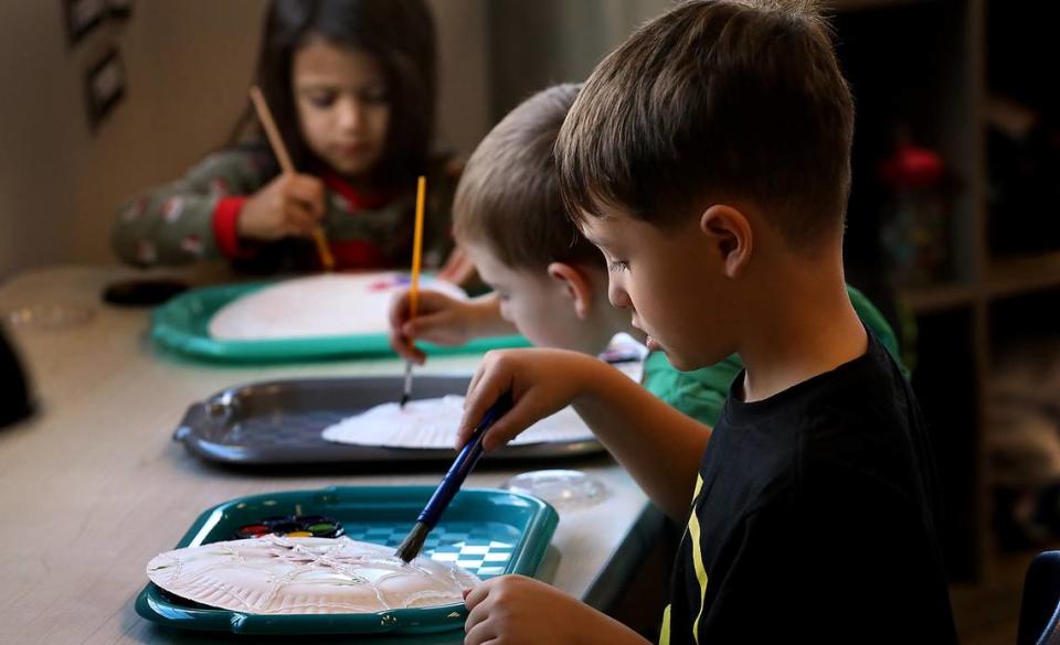 Damien Sullivan, a full-time preschool student at Level Up Learning, works near two classmates during their art and crafts session at the Kennewick childcare facility. Bob Brawdy/bbrawdy@tricityherald.com