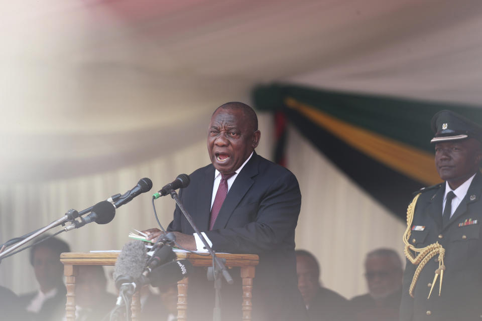 South African President Cyril Ramaphosa delivers his speech during the funeral ceremony of the late former Zimbabwean leader, Robert Mugabe at the National Sports stadium in Harare, Saturday, Sept, 14, 2019. African heads of state and envoys are gathering to attend a state funeral for Mugabe, whose burial has been delayed for at least a month until a special mausoleum can be built for his remains. (AP Photo/Tsvangirayi Mukwazhi)