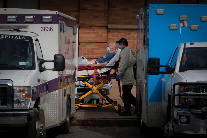 Paramedics take a patient into emergency center at Maimonides Medical Center during outbreak of coronavirus disease (COVID-19) in Brooklyn New York