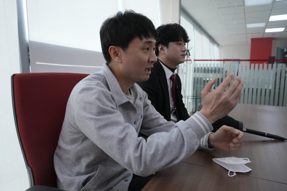 Hong Eun-pyo, left, speaks as Lee Jin-ouk listens during an interview in Seoul, South Korea, on Feb. 12, 2022. Hong Eun-pyo, a 39-year-old who runs an anti-feminist YouTube channel, justifies higher pay for men, insisting they put in longer hours or perform more difficult tasks. He says women shouldn’t complain about careers being slowed or cut by family caregiving needs because, unlike military service, having a child is a choice. (AP Photo/Ahn Young-joon)